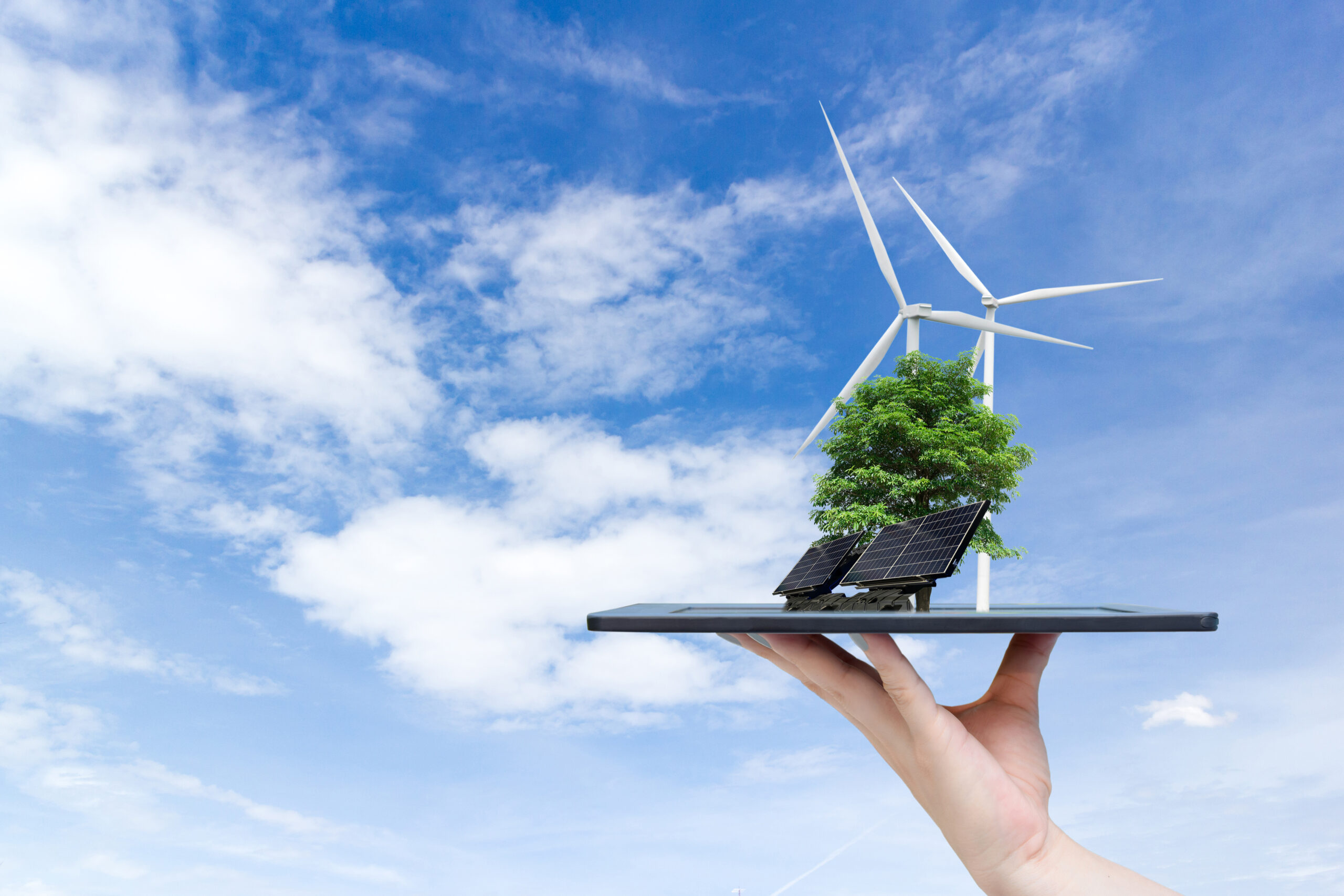 Ecological system solar energy in the city on the hand holding the tablet